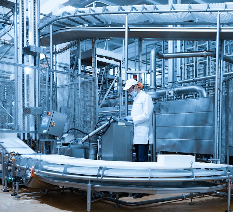 Man standing at controls of processing line