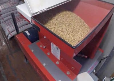 A roller mill being used in a brewery