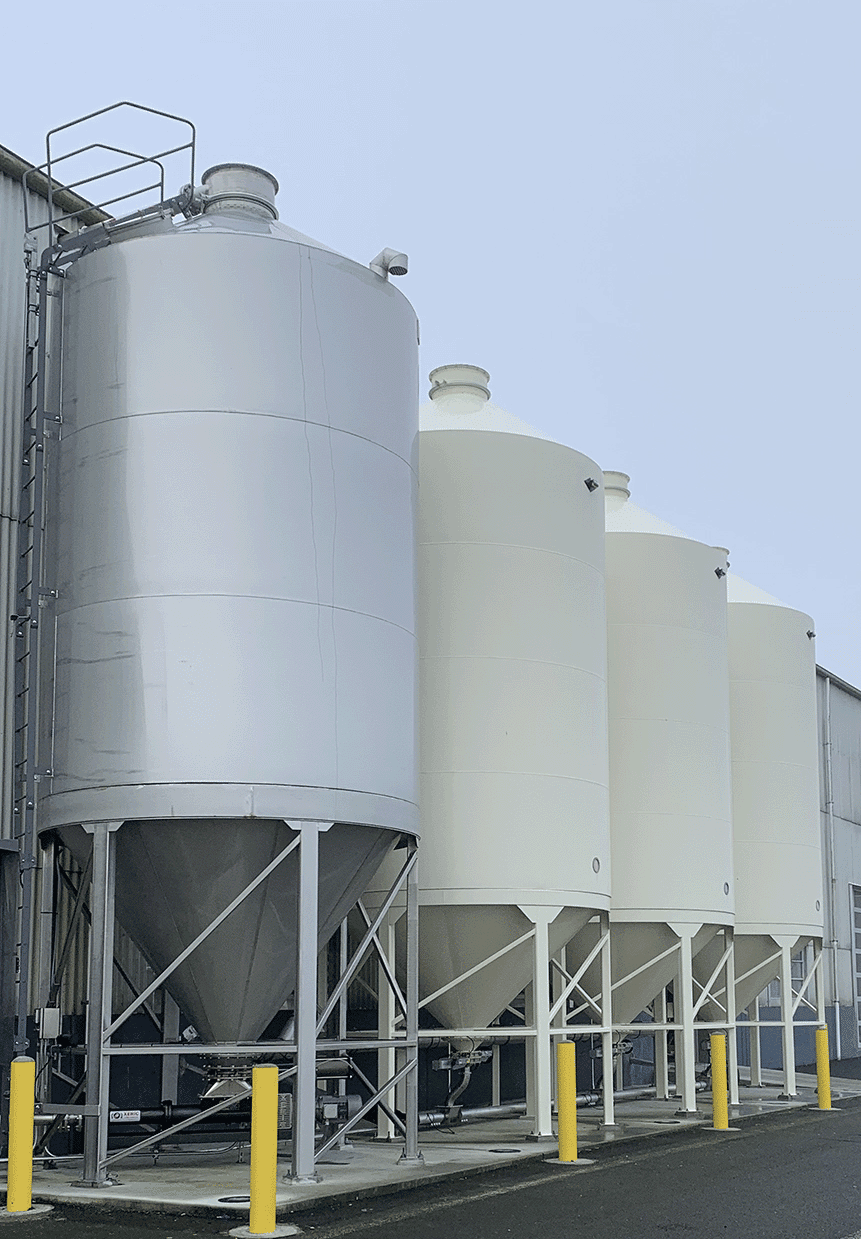 Stainless and powder-coated silos lined up