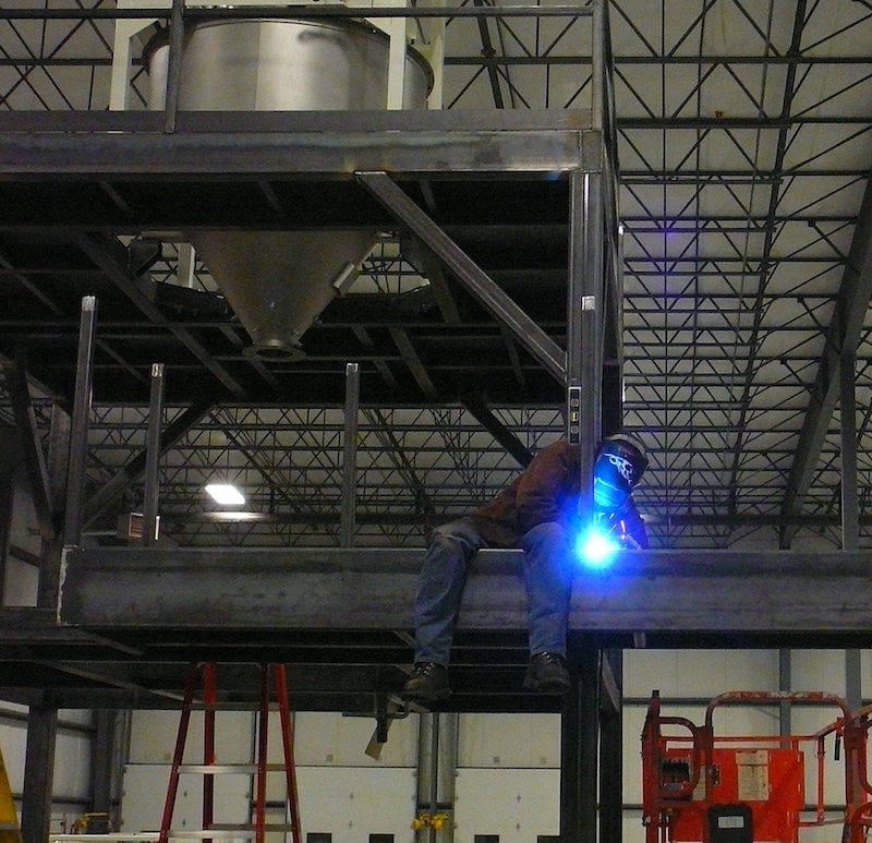 Fabricator welding industrial support structure on-site
